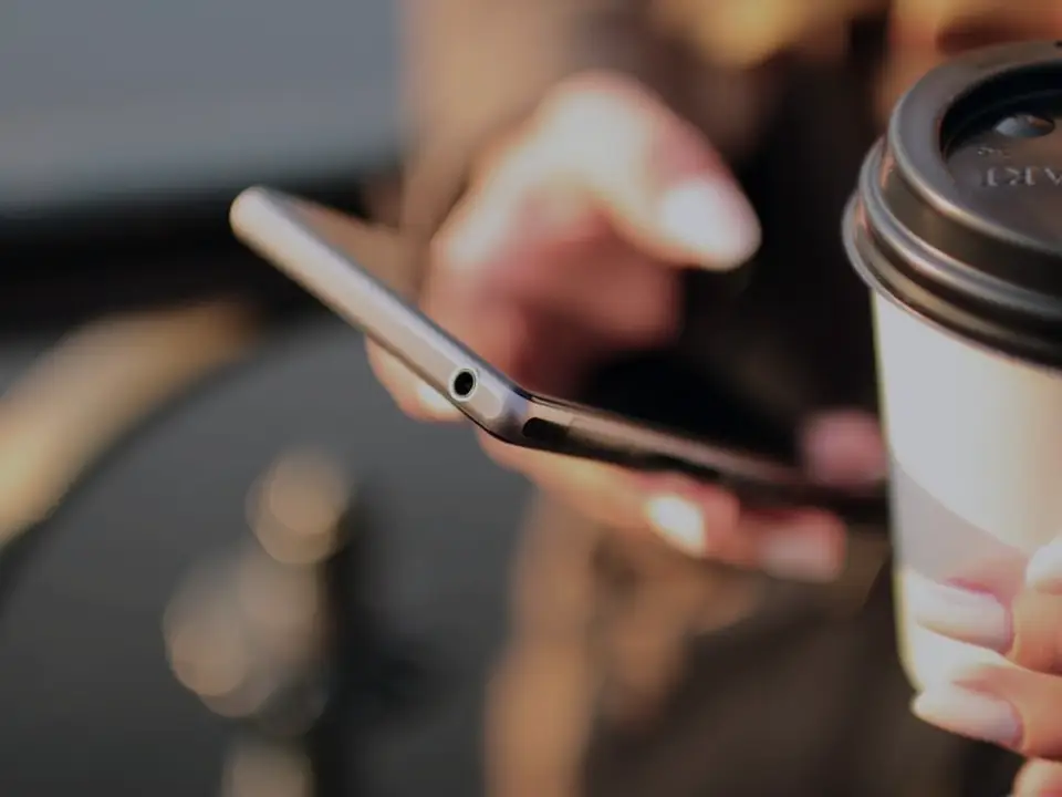 A phone and a cup of coffee