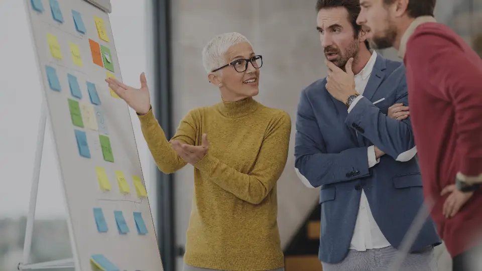 A team planning in front of a board of sticky notes