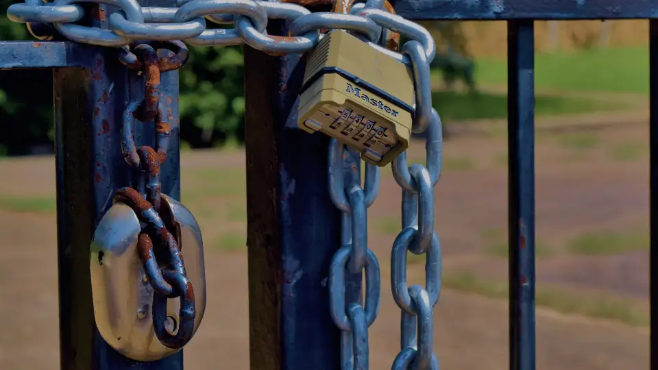 A padlock and chain on a gate